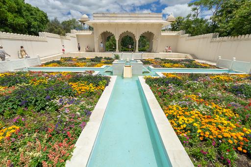 A temple with flowers and a river flowing in different directions