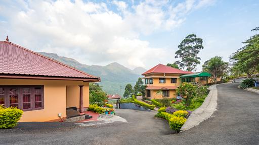 A house very high on a mountain and a road leading higher in the mountain