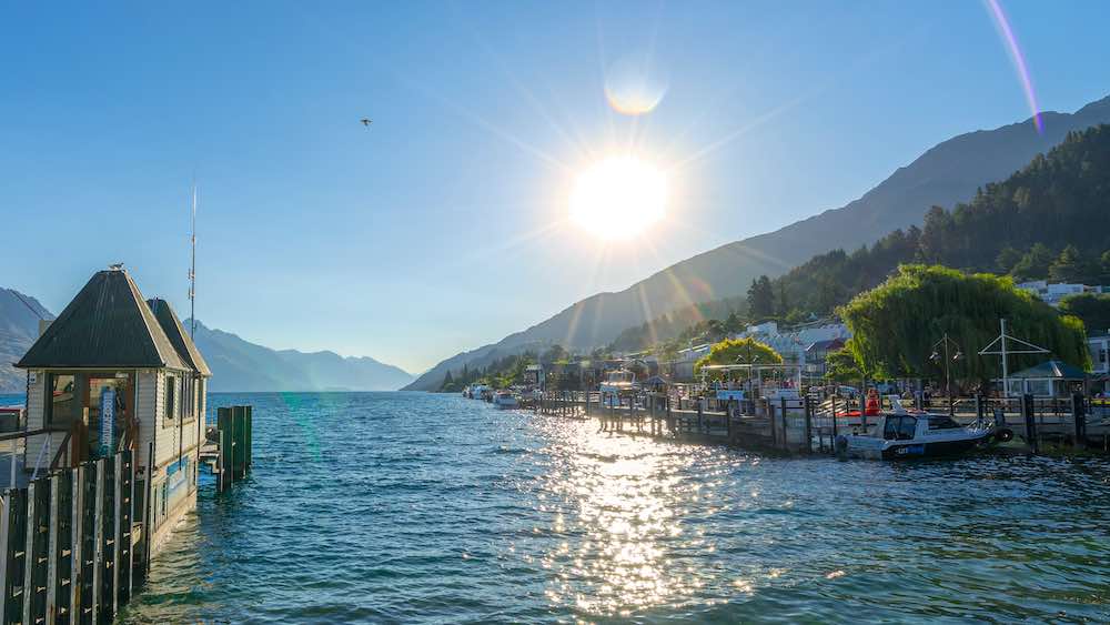 Mountains and some trees next to the water