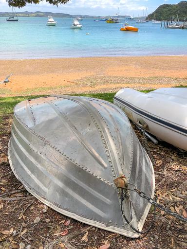 Two boats flipped upside down on the beach