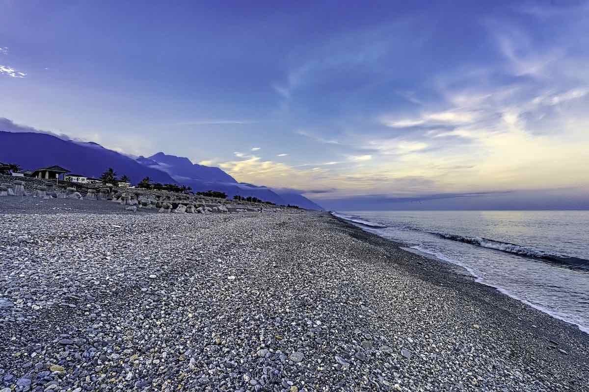 A beach with pebbles and stones on it